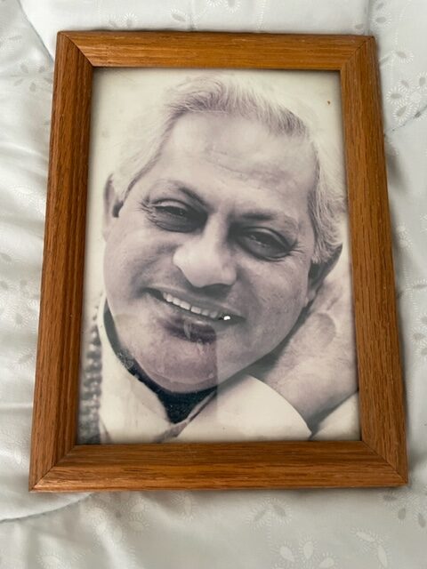 Black and white image of an old man in wooden frame