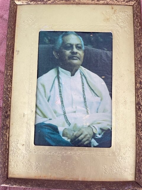 An Old Portrait Image of an Elderly Man in a Frame on the Wall